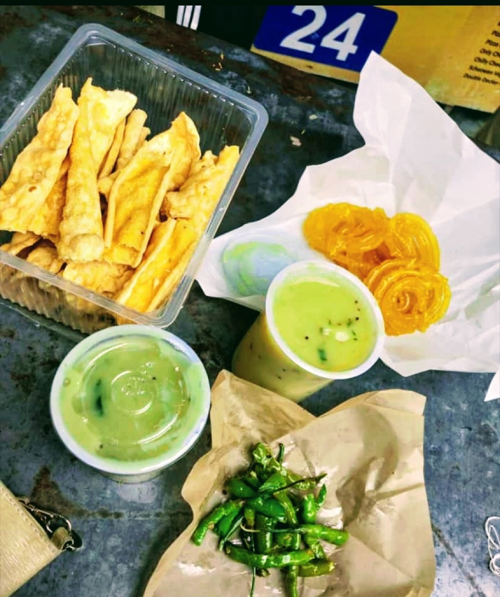 A plate of fafda and jalebi with chutney