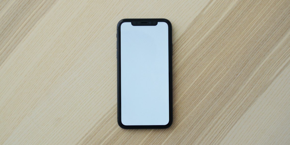Modern smartphone with multiple camera lenses on a sleek surface